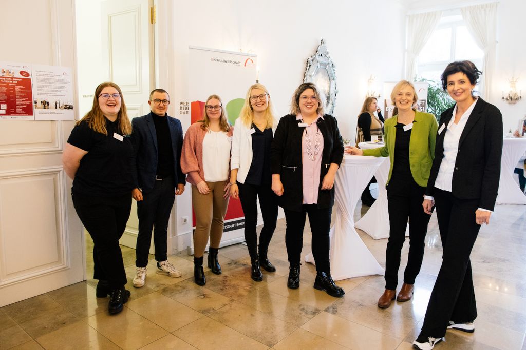 Sieben Personen im Foyer von Schloss Fürstenried nach der STARK‑Gütesiegelverleihung 2022 in gelöster Atmosphäre; Vertreter*innen der Beruflichen Schule 14 Nürnberg, rechts die STARK‑Projektleiterin und ganz rechts außen die Schulleiterin der Beruflichen Schule 14, Nürnberg
